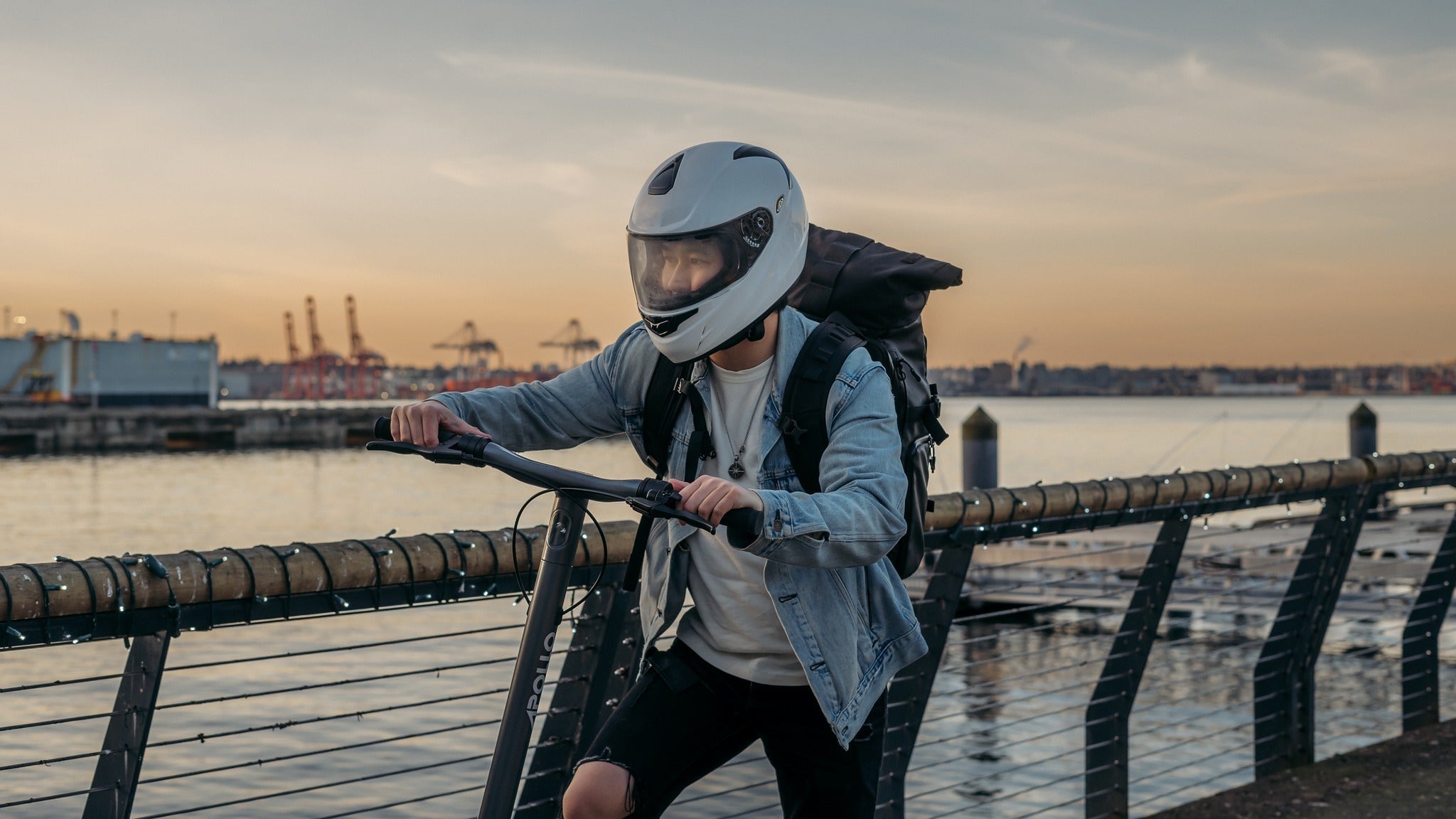 Image of a person riding an electric scooter on a city street, showcasing eco-friendly commuting and reduced carbon footprint