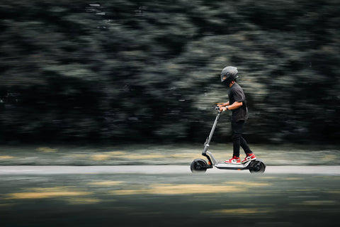 apollo scooter zipping along a forest