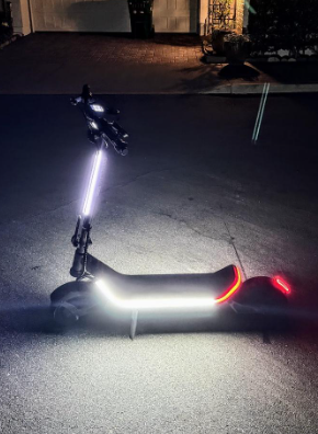 Apollo Electric Scooter at night with stem, deck, and rear light on