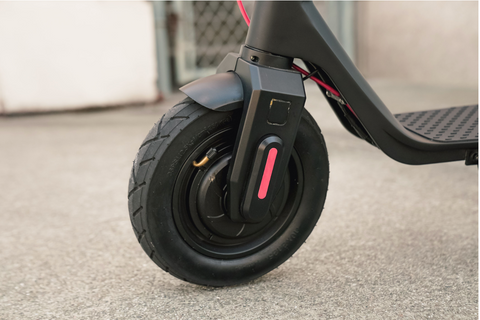 Side view of the Turboant X7 Max front wheel which has a pneumatic tire. It has a bent valve.